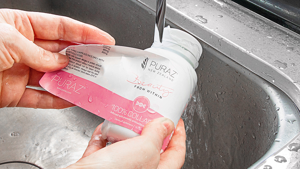 Puraz Collagen Infusion bottle run under a tap and the label is being peeled off
